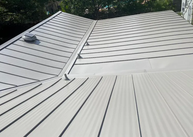 Solar attic fan installed on a metal roof for Roof Ventilation in Richmond Hill